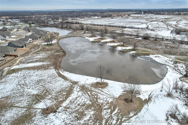 snowy aerial view with a water view