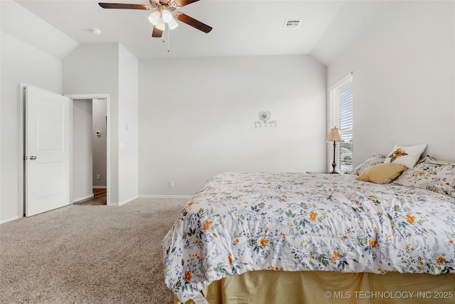 bedroom with ceiling fan, vaulted ceiling, and carpet flooring