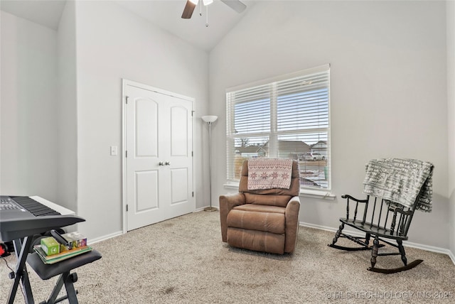 sitting room featuring ceiling fan, vaulted ceiling, and carpet floors