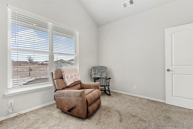 living area with lofted ceiling, light carpet, and plenty of natural light