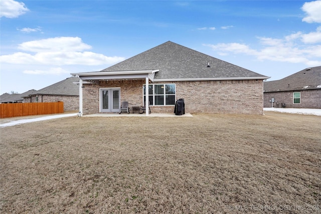 rear view of house featuring a lawn and a patio area