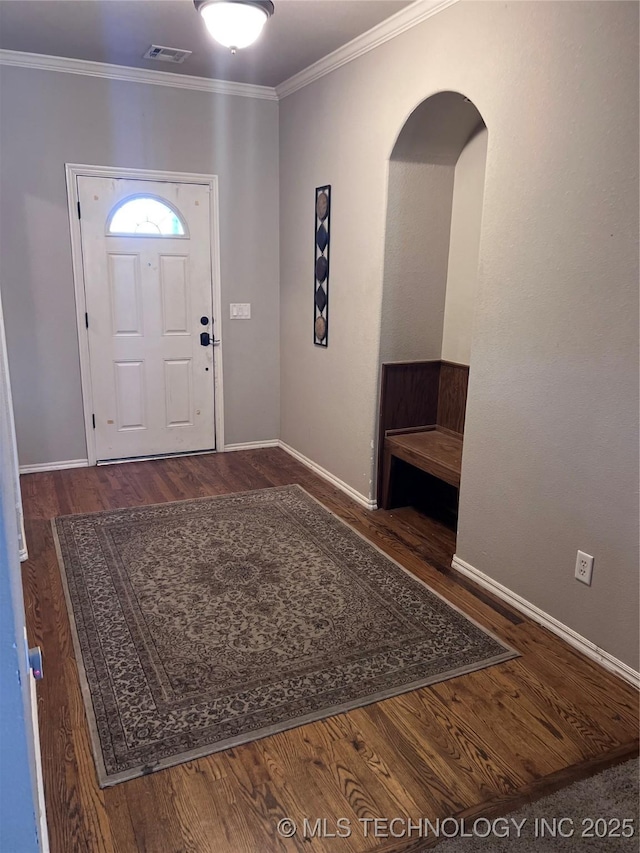 foyer entrance featuring dark hardwood / wood-style flooring and crown molding