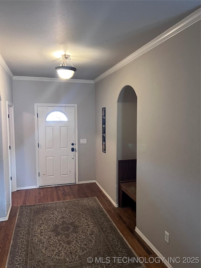 foyer entrance featuring dark hardwood / wood-style floors and crown molding