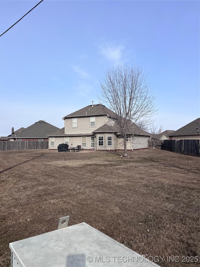 rear view of property featuring a yard