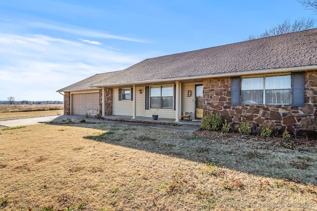 single story home featuring a front lawn and a garage