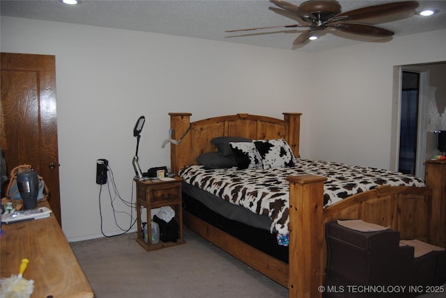 carpeted bedroom with a textured ceiling and ceiling fan