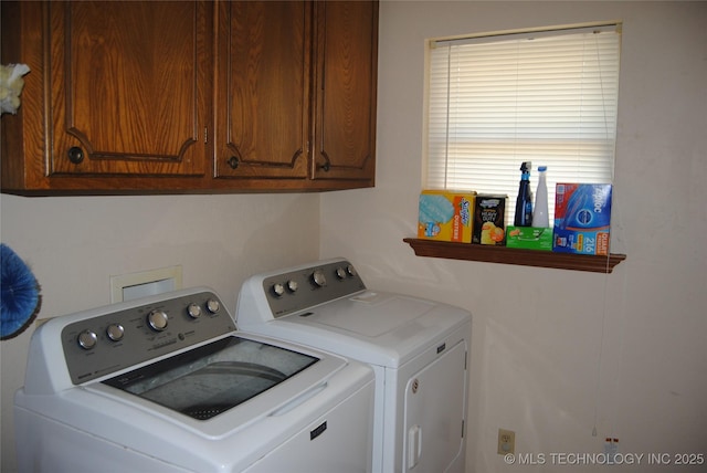 laundry room with washer and clothes dryer and cabinets