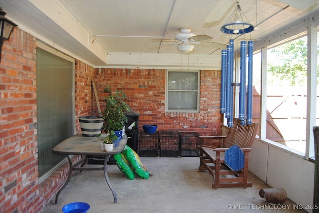 sunroom / solarium featuring ceiling fan