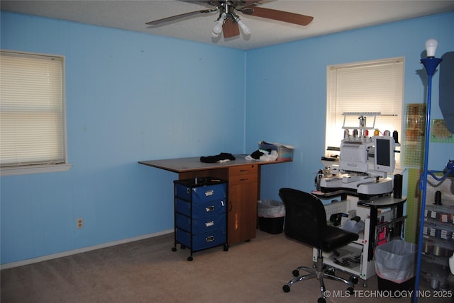 carpeted office featuring ceiling fan