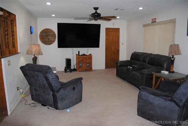 carpeted living room with a textured ceiling, ceiling fan, and ornamental molding