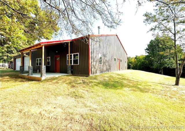 view of side of home with a lawn and a garage