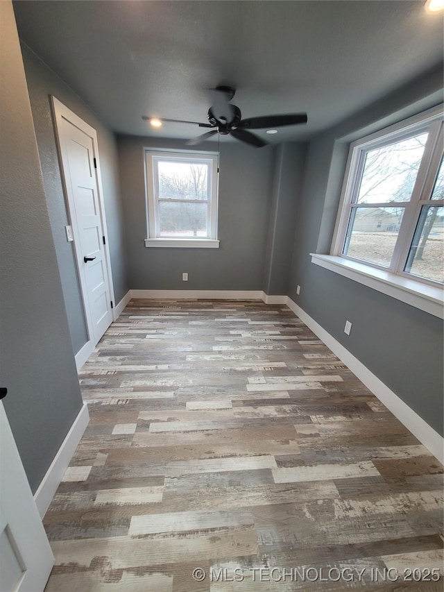 unfurnished bedroom with ceiling fan and light hardwood / wood-style flooring