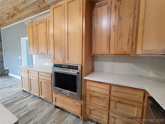 kitchen with stainless steel oven, light brown cabinets, light hardwood / wood-style flooring, light stone counters, and dishwashing machine