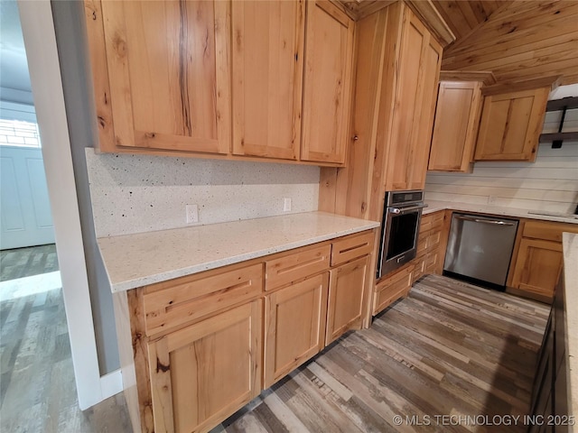 kitchen with stainless steel appliances, backsplash, lofted ceiling, wood-type flooring, and light stone countertops