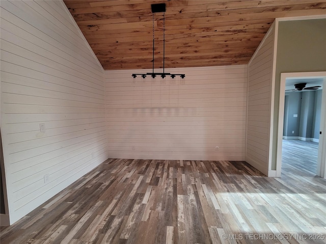 unfurnished dining area featuring lofted ceiling, wood walls, and wood ceiling