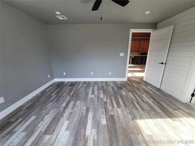 unfurnished room with ceiling fan and wood-type flooring