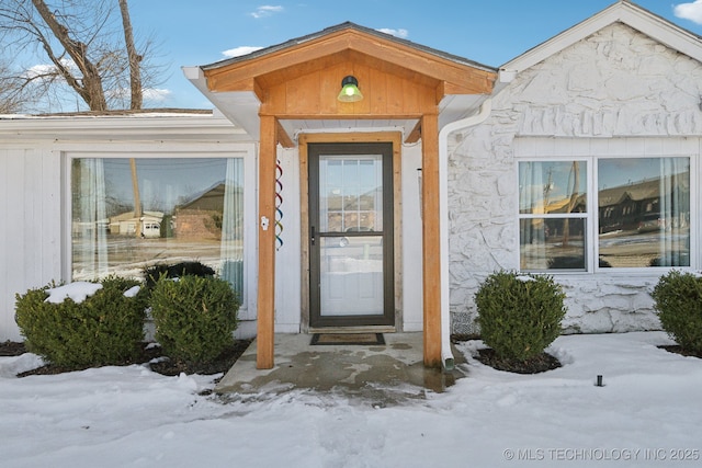 view of snow covered property entrance