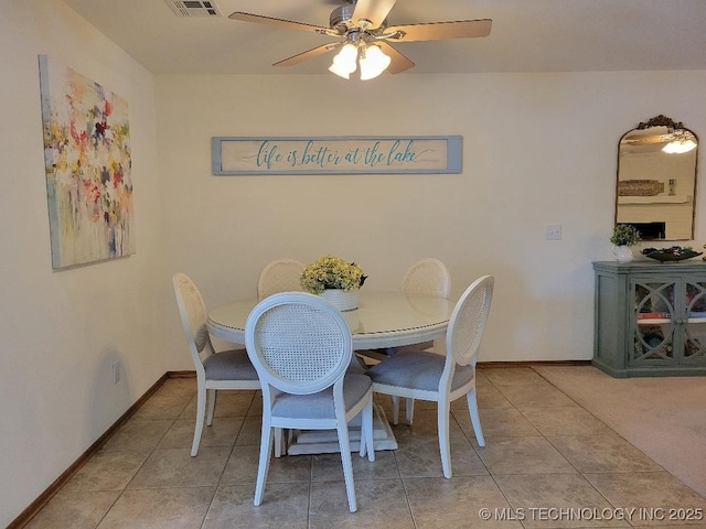 dining room featuring ceiling fan and tile patterned floors