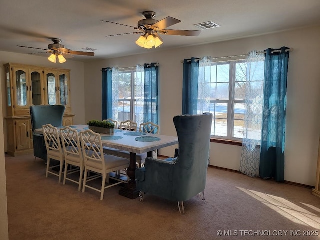 dining area with light colored carpet and ceiling fan