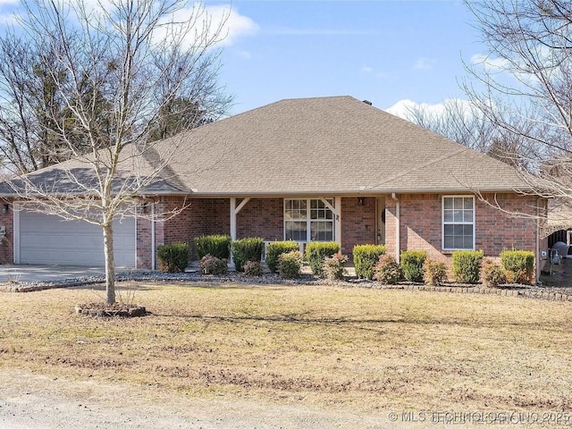 view of front of property with a front lawn and a garage