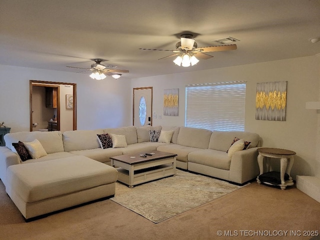 carpeted living room featuring ceiling fan