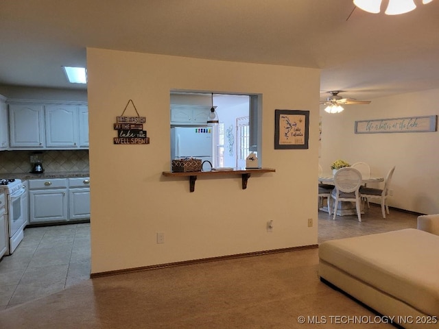 living room featuring ceiling fan and light tile patterned flooring