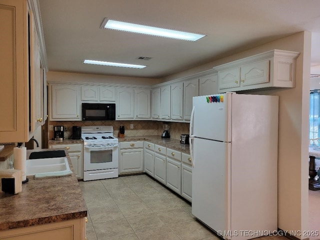 kitchen featuring sink, white cabinets, white appliances, light tile patterned floors, and backsplash