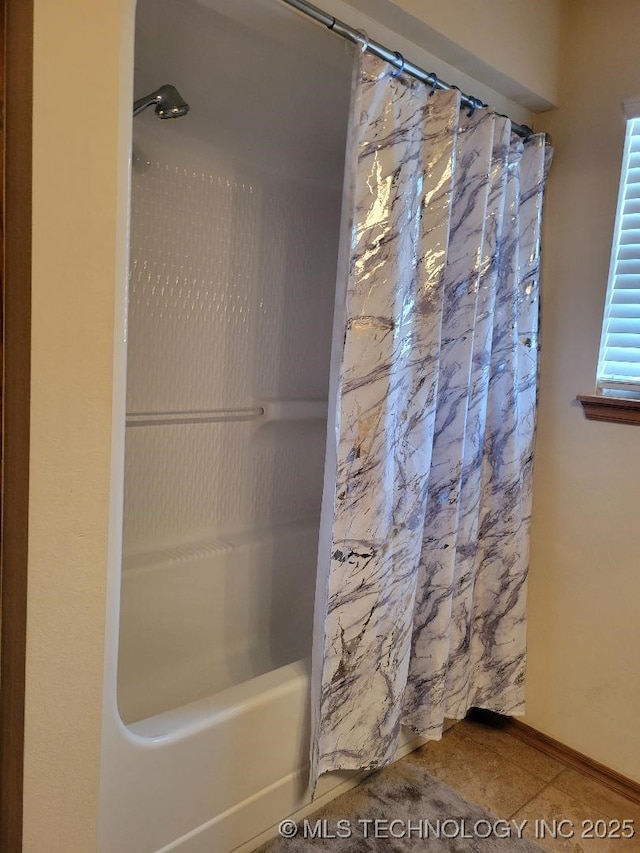 bathroom featuring tile patterned flooring and shower / bath combo with shower curtain