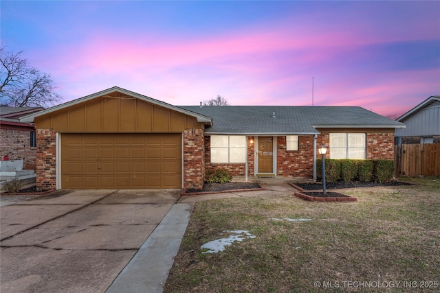 ranch-style home with a lawn and a garage