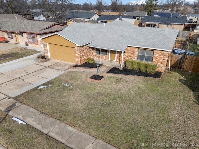 ranch-style house featuring a front yard and a garage