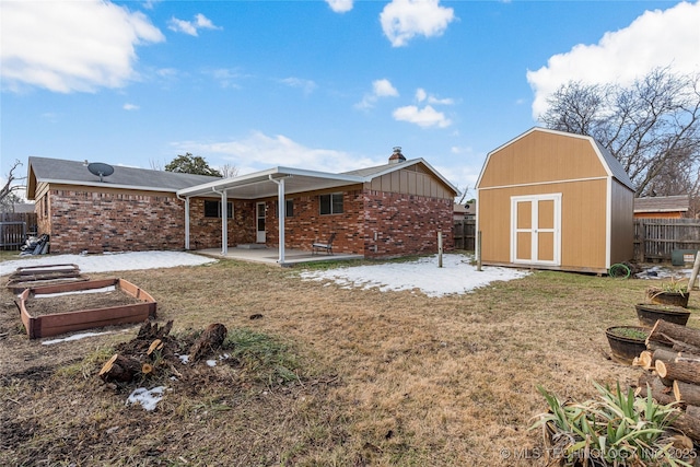 back of property featuring a patio, a yard, and a shed