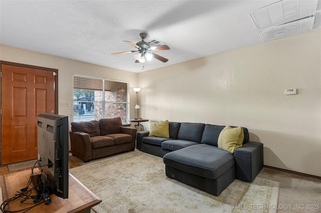 living room with a textured ceiling and ceiling fan