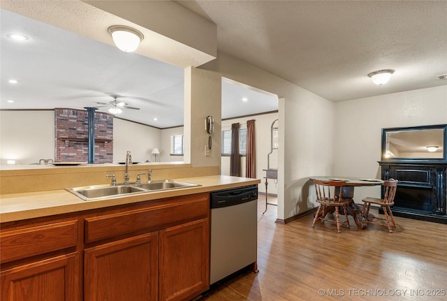 kitchen featuring sink, a textured ceiling, dishwasher, ceiling fan, and dark hardwood / wood-style floors