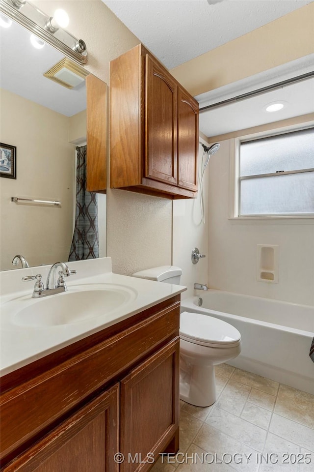 full bathroom with shower / bath combination with curtain, vanity, and toilet