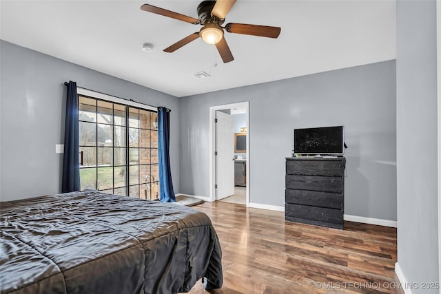 bedroom featuring ceiling fan, dark hardwood / wood-style flooring, and ensuite bath