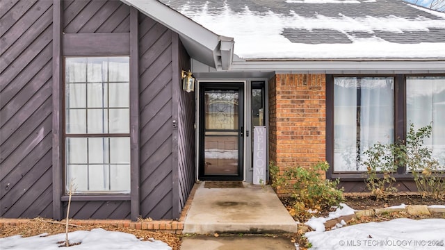 view of snow covered property entrance