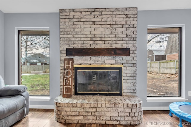 room details with a brick fireplace and wood-type flooring