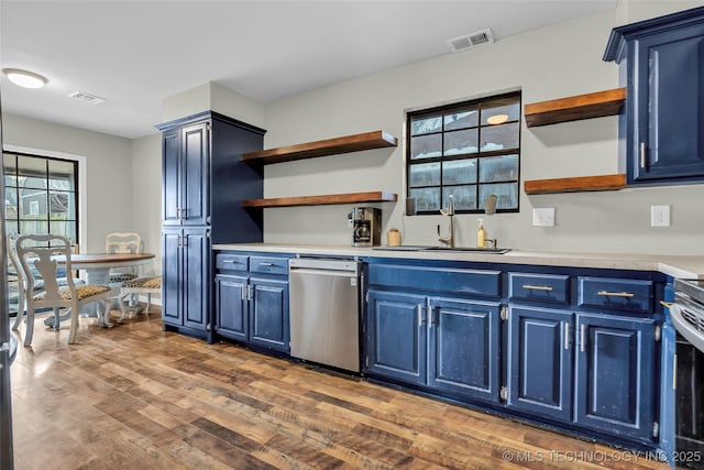 kitchen featuring dark wood-type flooring, dishwasher, blue cabinetry, and sink