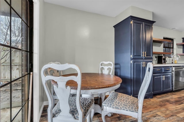 dining space featuring sink and dark hardwood / wood-style flooring