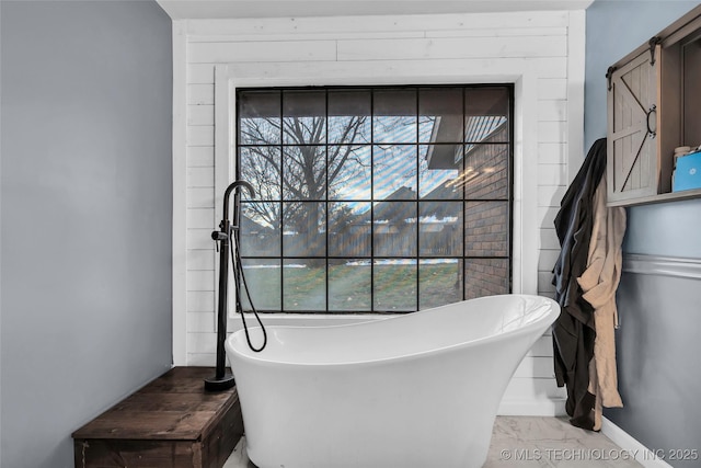 bathroom featuring plenty of natural light and a bathing tub