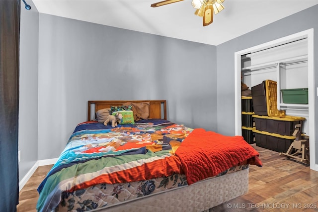 bedroom with a closet, ceiling fan, and light hardwood / wood-style flooring