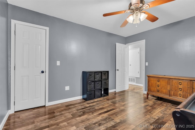 interior space featuring ceiling fan and dark hardwood / wood-style floors