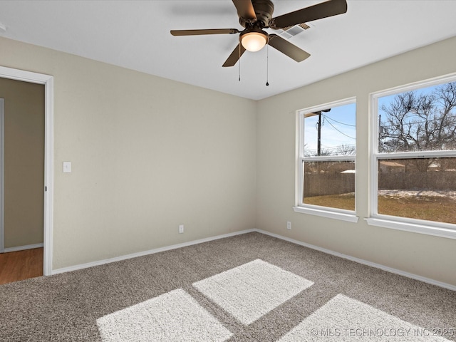 spare room with carpet floors and ceiling fan