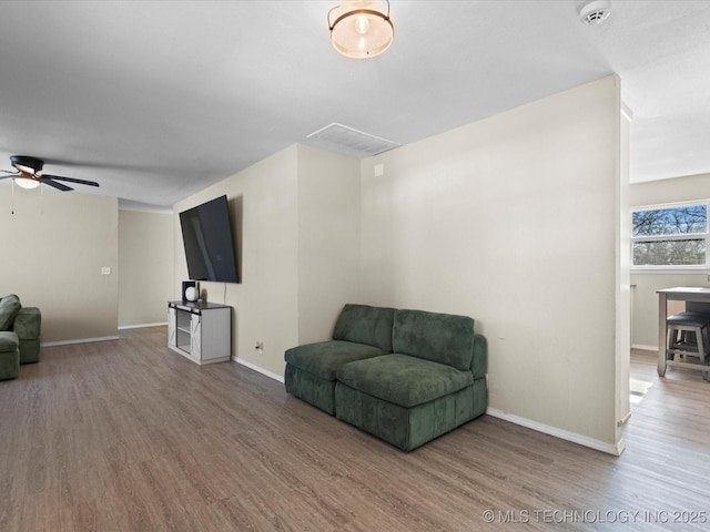 sitting room with ceiling fan and hardwood / wood-style flooring