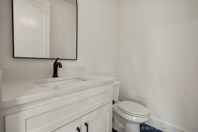 bathroom featuring toilet and vanity