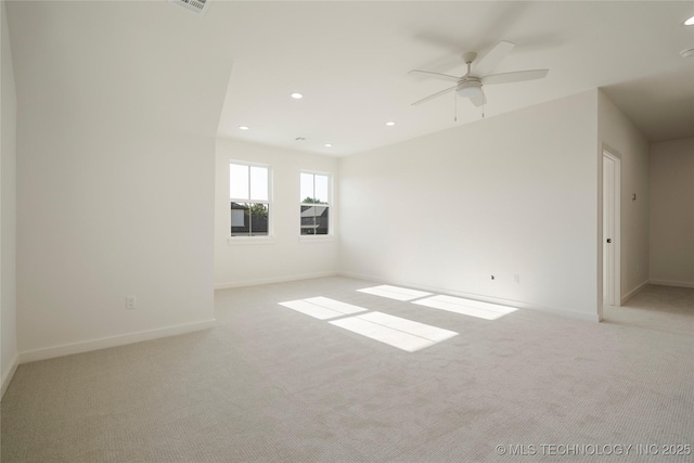 carpeted spare room featuring ceiling fan