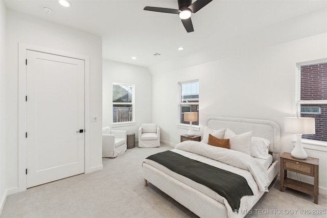 carpeted bedroom with vaulted ceiling and ceiling fan