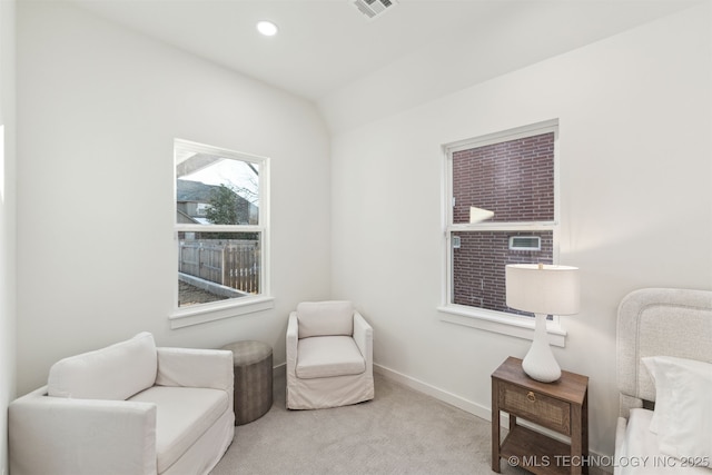 sitting room with light carpet and vaulted ceiling