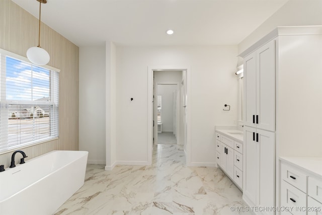 bathroom featuring vanity and a tub