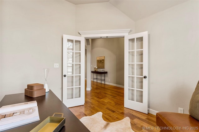 office area featuring french doors, hardwood / wood-style floors, and vaulted ceiling